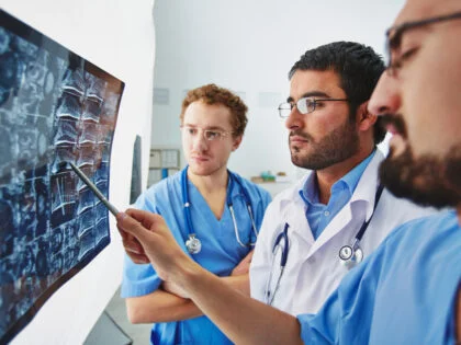 doctor pointing to xrays infront of medical students