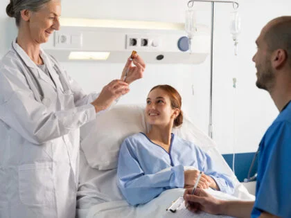 doctor and a nurse attending patient in a bed