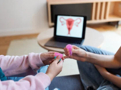 High angle hands holding menstrual cups