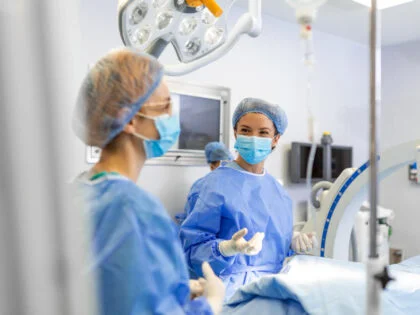 Young woman doctor in surgical uniform in hospital operation theater