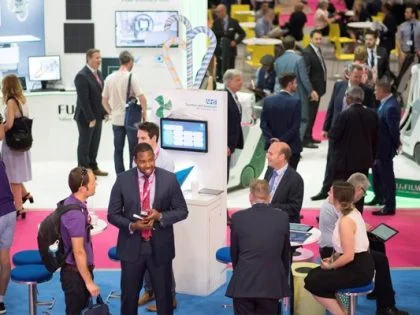 a crowd of people in suits at a convention