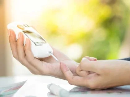 female using diabetes testing equpment