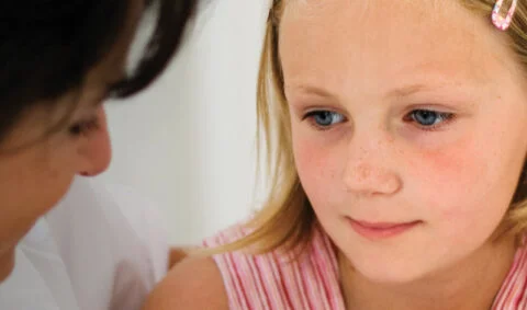 Online safeguarding children course levels 1 and 2 - female in white coat comforting girl in pink top