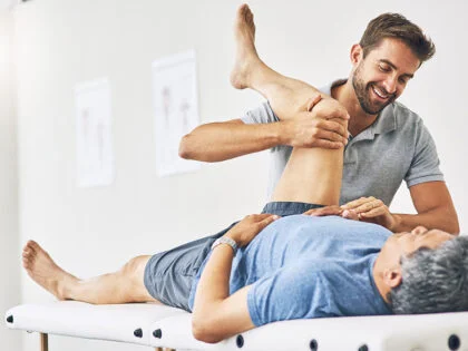 Male chiropractor with patient